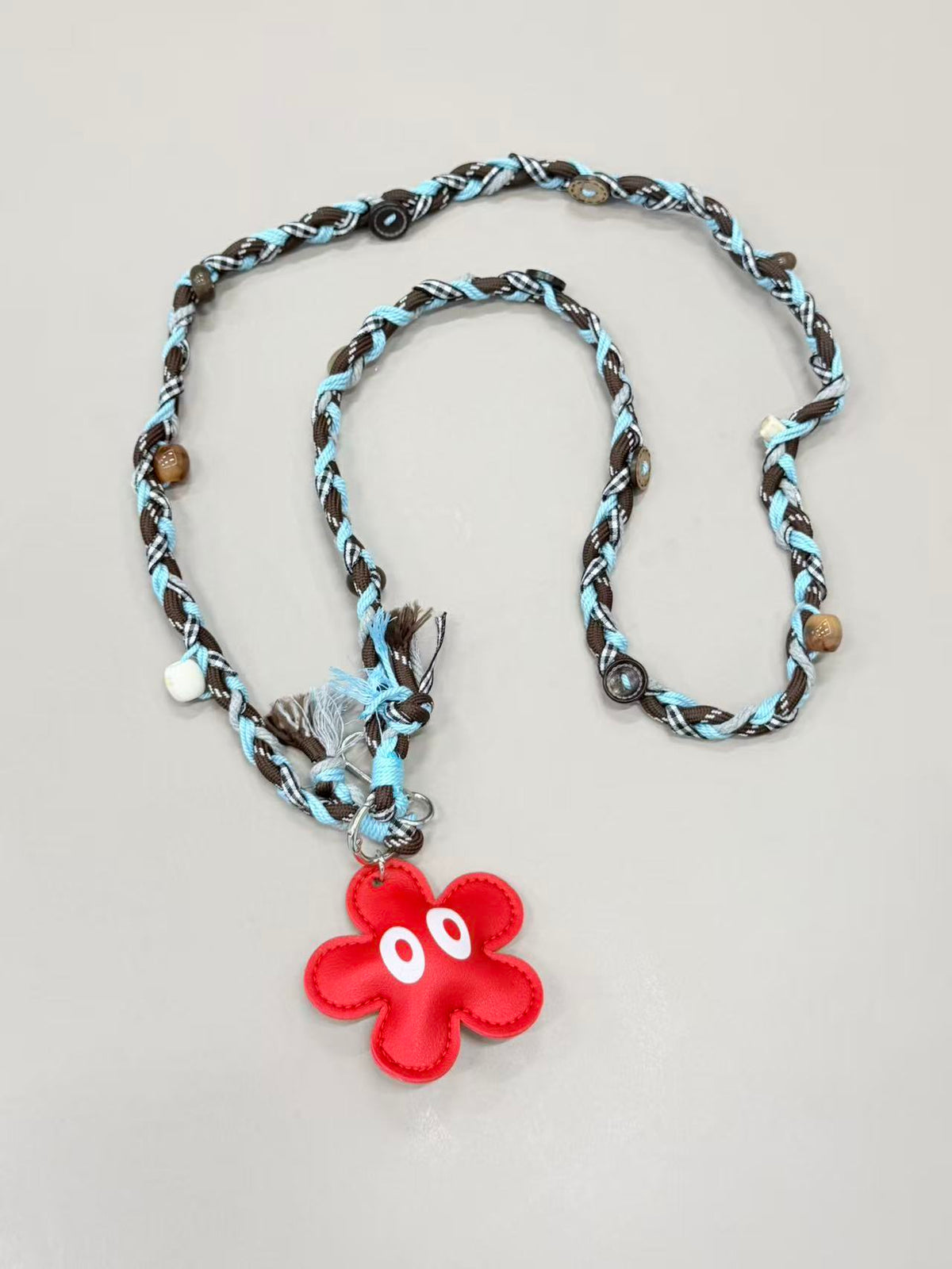 Brown blue braided phone lanyard with flower charm